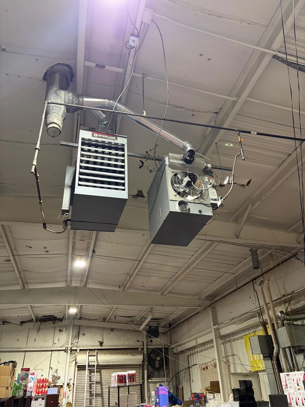 Sterling commercial overhead gas unit heaters hanging in warehouse